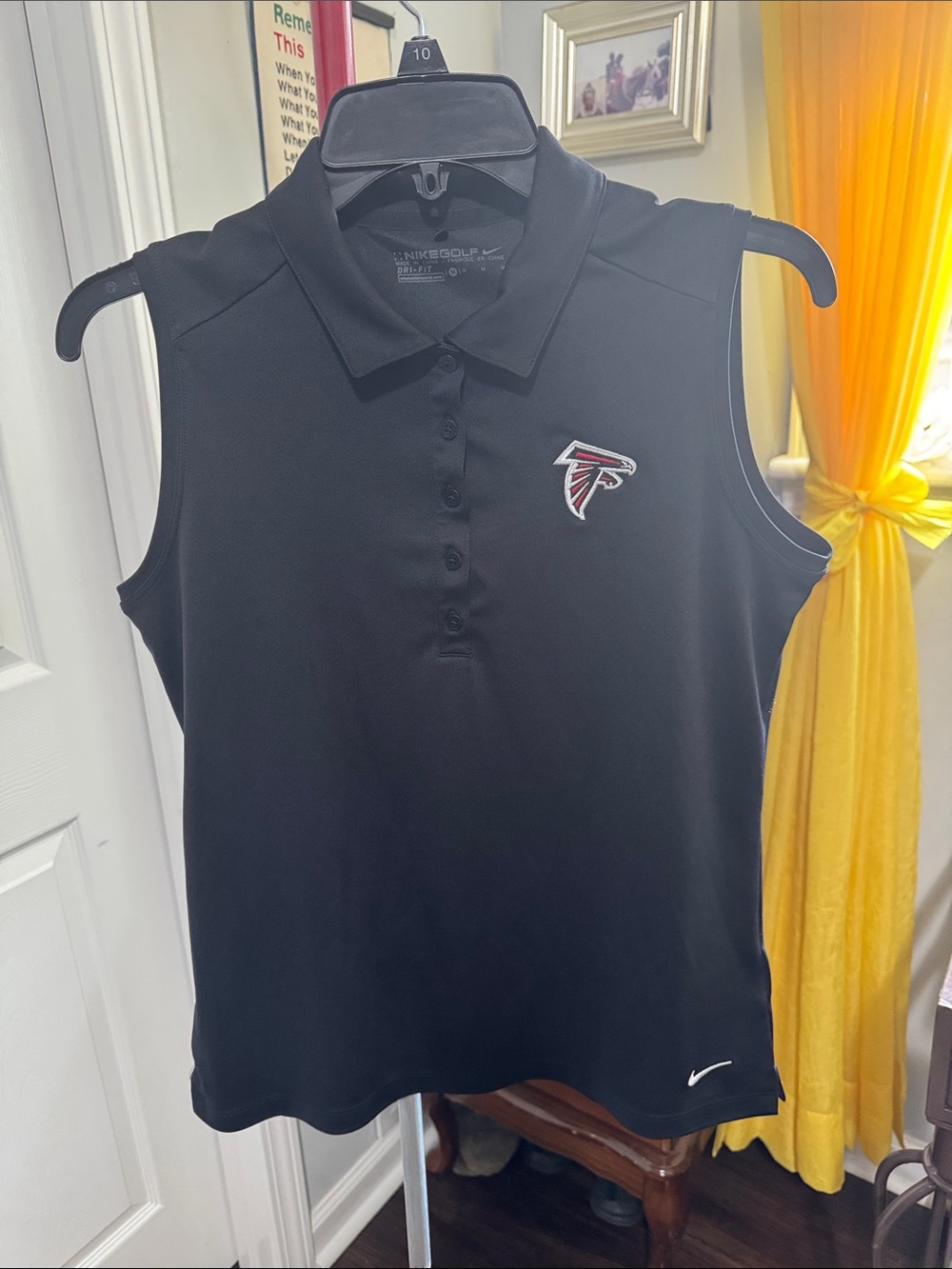 Nike Black Sleeveless Polo with Atlanta Falcons Patch. Woman’s shirt size M